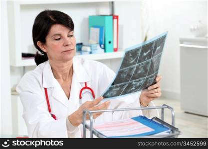 A doctor examining a radiography.