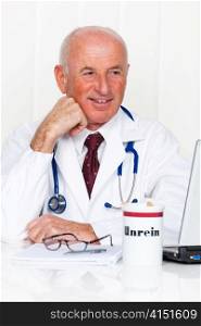 a doctor in his medical practice with stethoscope and laptop computer.