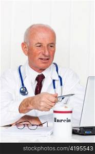 a doctor in his medical practice with stethoscope and laptop computer.