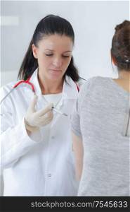 a doctor injecting patients hand