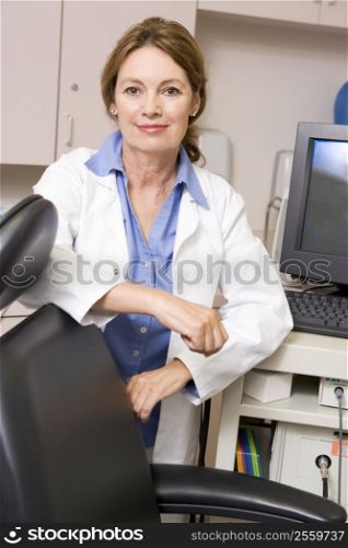 A Doctor Standing By A Computer Monitor