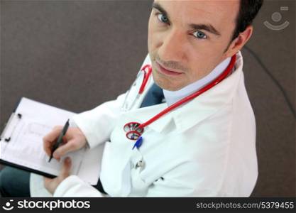 a doctor writing on a paper