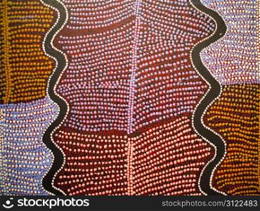 A dot pattern painted on cloth fabric provides a rich background.