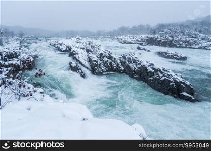 A dramatic snowy scene of the Potomac River at Great Falls Park in Northern Virginia.