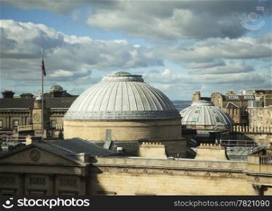 A dramatic view, just before sunset, of the rooftops of the New Town area of Edinburgh. The copper domes are part of one of the museums in the city.