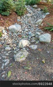 A dry stream bed in Bellevue, Washington waits for rain.