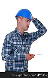 A dubious handyman with a screwdriver.