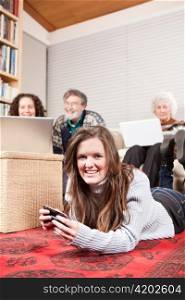 A family at home using wireless technology such as laptop and cell phone