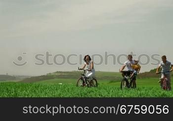 A family cycling in the summer time