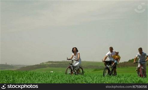A family cycling in the summer time
