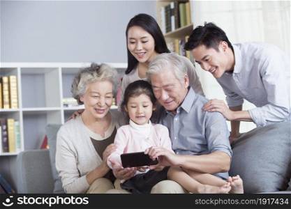 A family of five using a mobile phone