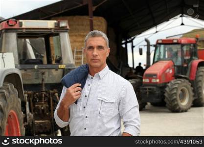A farmer posing with his tractors