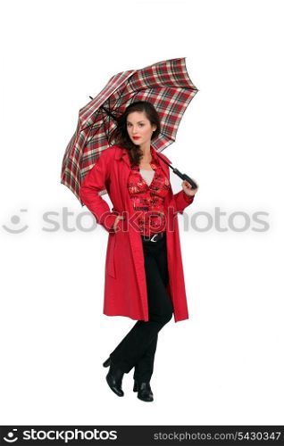 A fashionable woman holding an umbrella