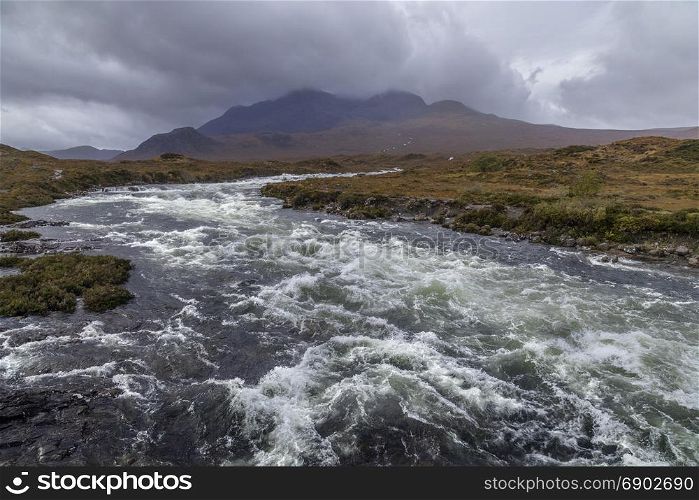A fast flowing river in the Cuillin Hills on the Isle of Skye in the Inner Hebrides of northwest Scotland.