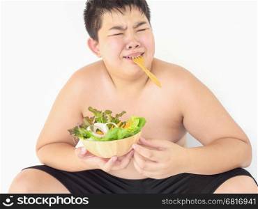 A fat boy hate to eat vegetable salad