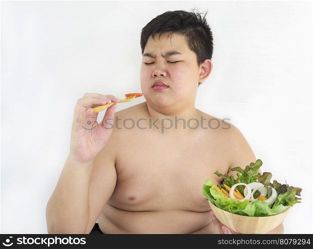 A fat boy hate to eat vegetable salad