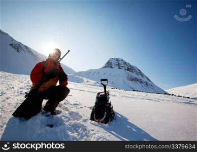 A female adventure loading a rifle as a safety precatuion, Svalbard, Norway