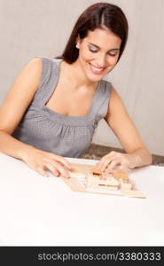 A female architect designing a scale model house