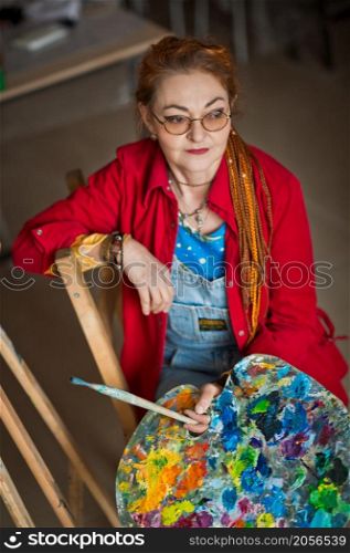 A female artist in a creative setting.. Portrait of a creative person in a working environment 2931.