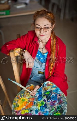 A female artist in a creative setting.. Portrait of a creative person in a working environment 2932.