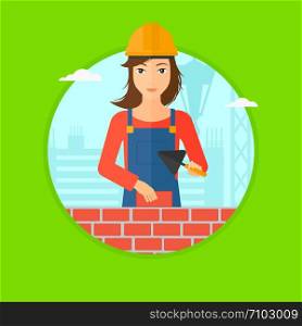 A female bricklayer in uniform and hard hat with a spatula and a brick in hands on a background of construction site. Vector flat design illustration in the circle isolated on background.. Bricklayer with spatula and brick.