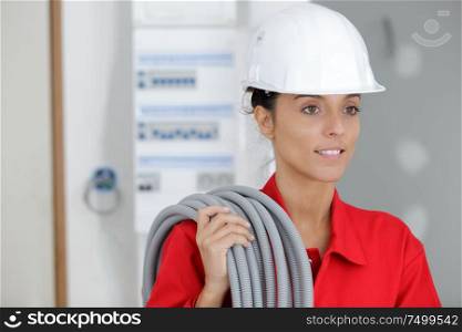 a female builder holiding pipes