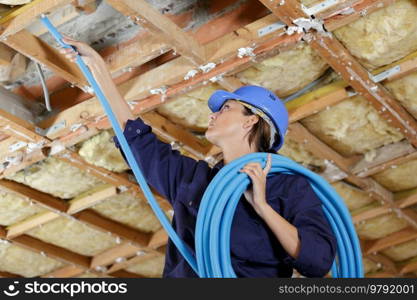 a female builder with pipes