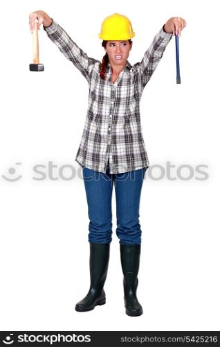 A female carpenter repulsed by her tools.