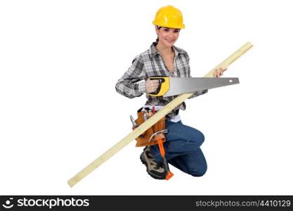 A female carpenter with a handsaw.