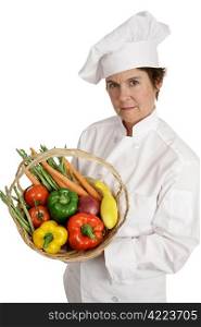 A female chef holding a basket of vegetables with a serious expression. She takes nutrition seriously. Isolated on white.