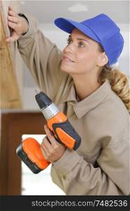 a female construction worker drilling