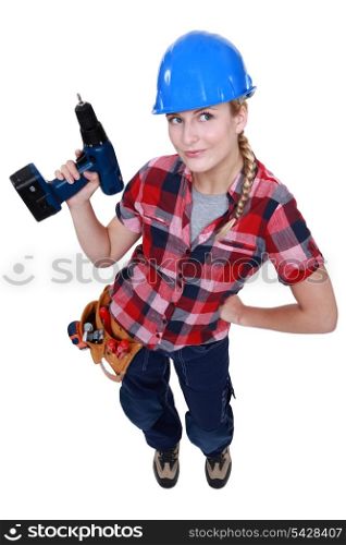 A female construction worker holding a drill.
