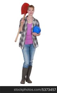 A female construction worker holding a shovel.