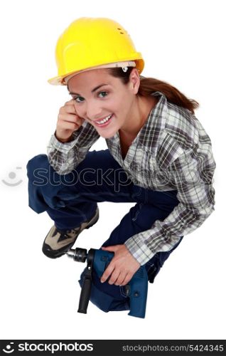 A female construction worker with a drill.
