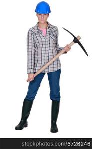 A female construction worker with a pickaxe.