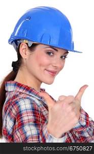 A female construction worker with both thumbs up.