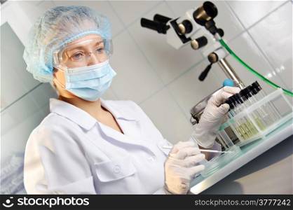 A female doctor examines a sample. &#xA;Could be useful for medicine, hospital, research and development, clinical studies, forensics, science etc