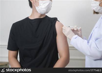 A female doctor injecting covid-19 vaccine to patient arm, covid-19 vaccination and health care concept. Female doctor injecting covid-19 vaccine to patient arm, covid-19 vaccination and health care concept