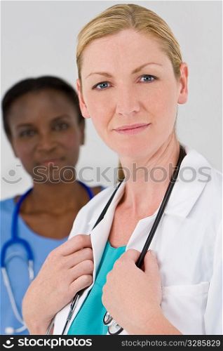 A female doctor with her African American colleague out of focus behind her