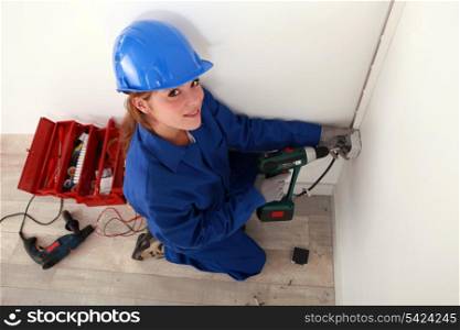A female electrician at work.