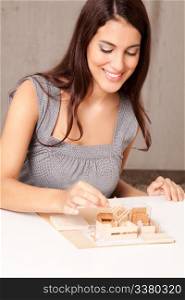 A female interior architect designign a scale model house