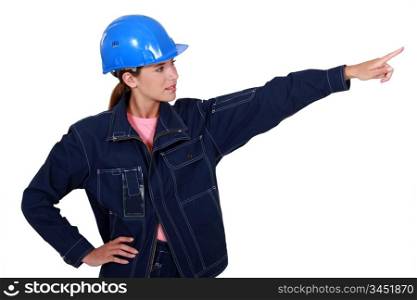 A female manual worker pointing at something.