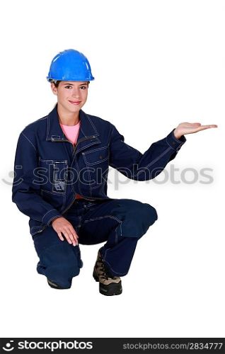 A female manual worker presenting something.