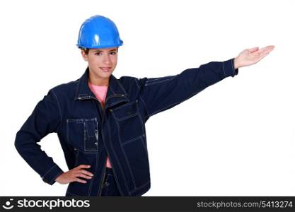 A female manual worker presenting something.