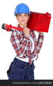 A female manual worker with a toolbox and a wrench.