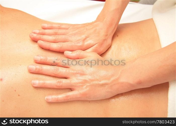 A female masseur giving a back massage
