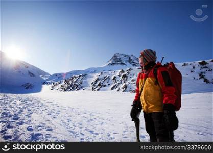 A female mountaineer against a winter mountain landscape