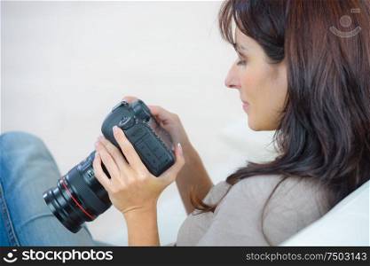 a female photographer checking pictures