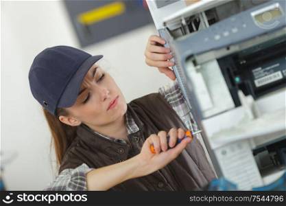 a female technician fixing printer