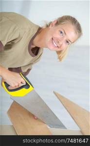 a female worker cutting a plywood